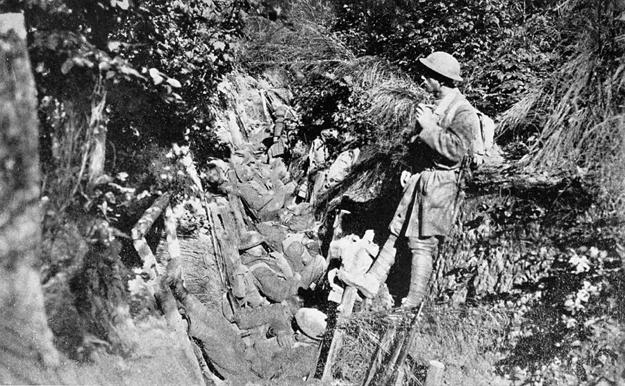 World War I: American soldiers resting in a shallow trench in the Argonne Forest.