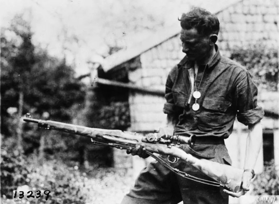 American soldier displaying a camouflaged Springfield rifle with a telescopic sight, Badonviller, 18 May 1918