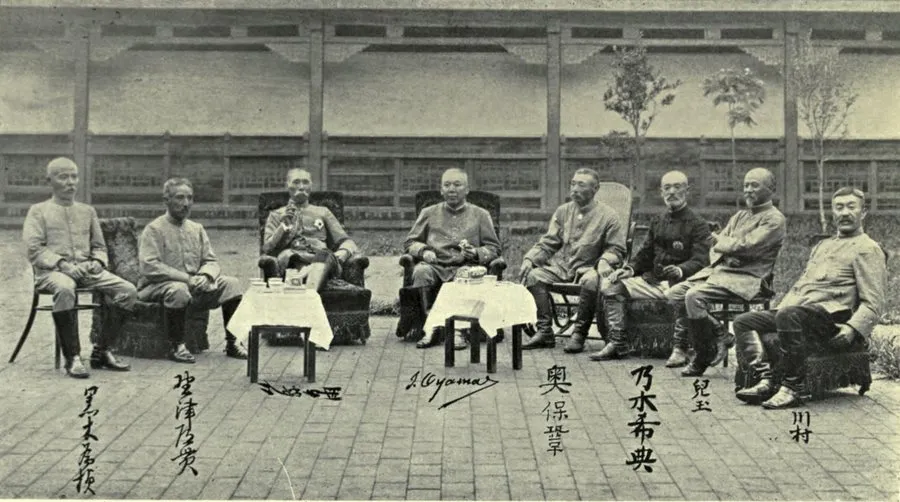 Eight Japanese generals seated at tea tables in a paved courtyard, their names written beneath them