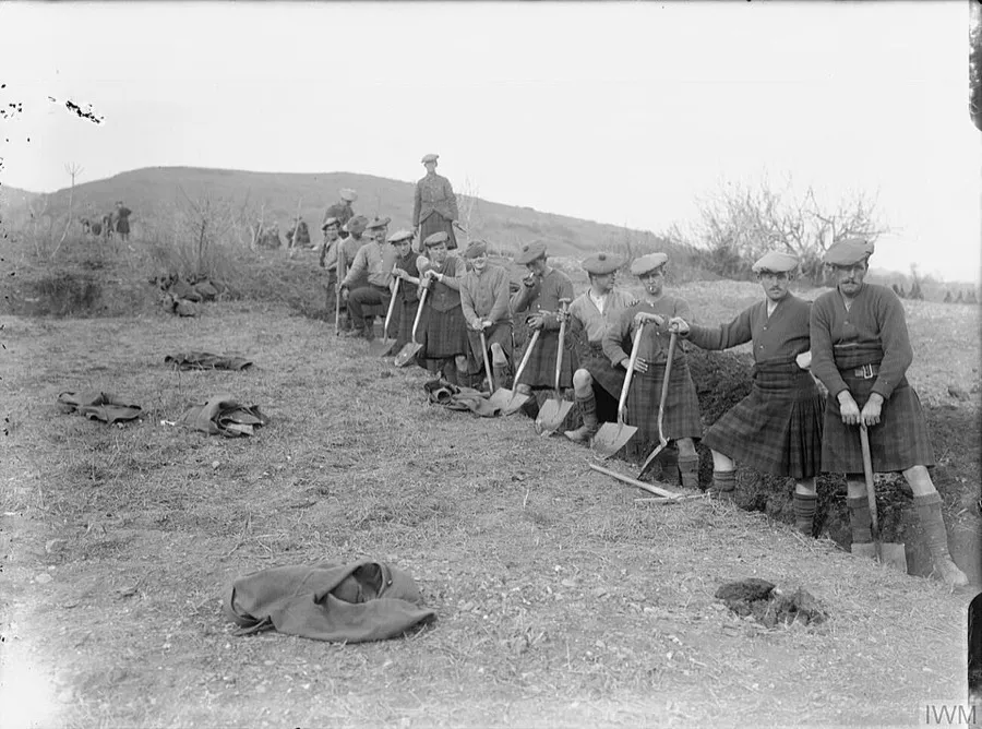 Men of the 10th (Service) Battalion, Black Watch (26th Division) take a break from digging trenches in the hills between the villages of Aiv