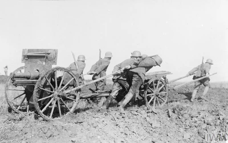 German stormtroopers from World War I hauling a converted Russian 76.2 mm field gun across no man's land.